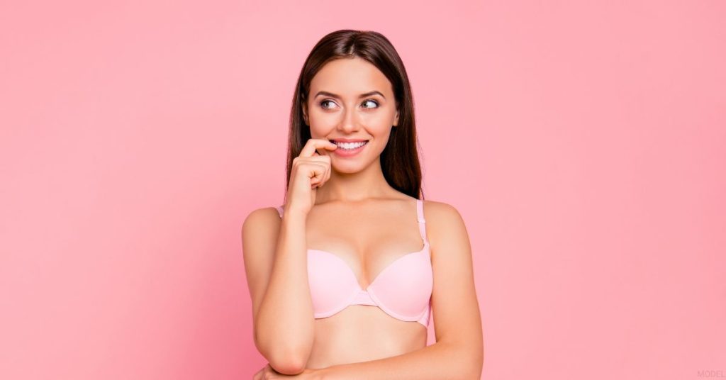 Woman in pink underwear posing on a pink background. (MODEL)