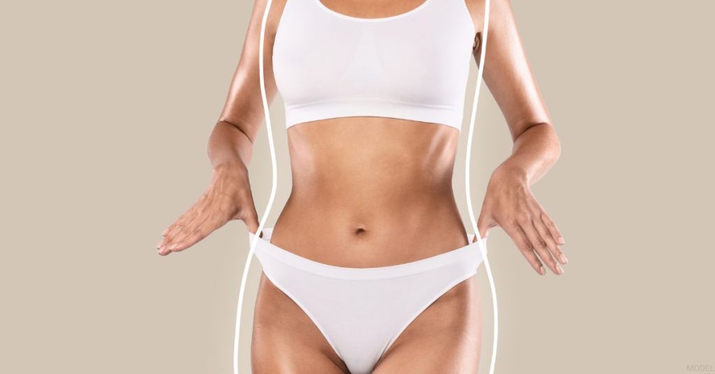 Woman in a white bikini top standing in front of a beige background (MODEL)