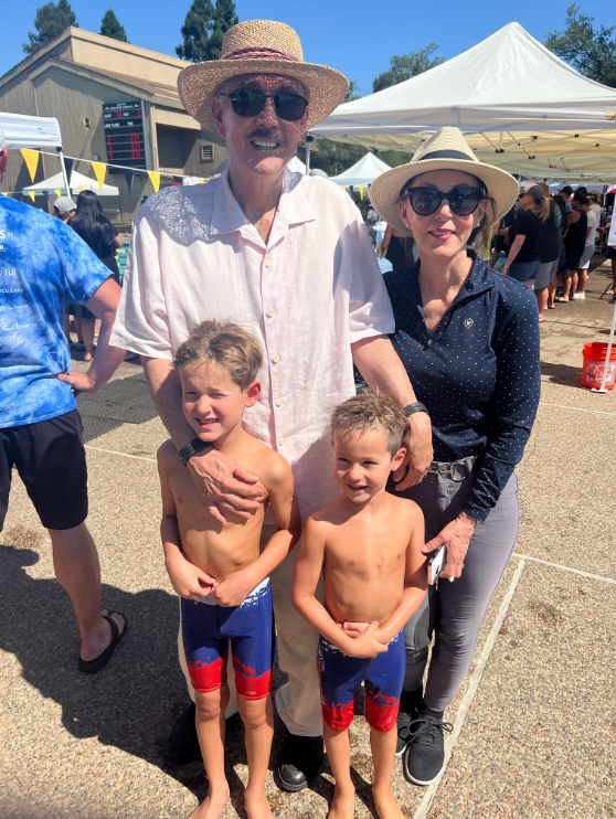 Dr Yamahata standing and smiling with his family